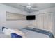 Tranquil bedroom with a TV, ceiling fan, closet, and soft, neutral color scheme at 925 Beach Rd # 408, Sarasota, FL 34242