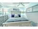 Charming bedroom with a comfortable bed, dresser, and serene decor at 925 Beach Rd # 408, Sarasota, FL 34242