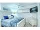 Well-lit bedroom featuring a mounted TV, a window, and soft, inviting colors at 925 Beach Rd # 408, Sarasota, FL 34242