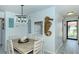 Charming dining area with rustic table, coastal decor, and a pass-through to the kitchen at 925 Beach Rd # 408, Sarasota, FL 34242