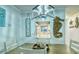 Charming dining room featuring beach-themed decor, stylish lighting, and a view into the bright, modern kitchen at 925 Beach Rd # 408, Sarasota, FL 34242