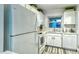 Updated kitchen featuring white appliances and cabinets, and modern fixtures at 925 Beach Rd # 408, Sarasota, FL 34242
