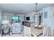 Inviting living area flowing into dining space, decorated with beach-themed artwork and furnishings at 925 Beach Rd # 408, Sarasota, FL 34242