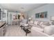 Bright living room showcasing a comfortable sofa, stylish decor, and an inviting view of the dining area at 925 Beach Rd # 408, Sarasota, FL 34242