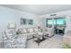 Relaxing living room with comfy seating, coastal decor, and balcony access at 925 Beach Rd # 408, Sarasota, FL 34242