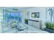 Bright living room with light coastal decor, sliders to balcony, and a flat screen TV at 925 Beach Rd # 408, Sarasota, FL 34242