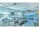 Living room features comfortable seating and view of the balcony and outdoor scenery at 925 Beach Rd # 408, Sarasota, FL 34242