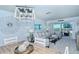 Open-concept living and dining area with view of balcony and contemporary decor at 925 Beach Rd # 408, Sarasota, FL 34242