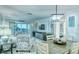 Open-concept living room featuring a view of the water, comfortable seating, and stylish coastal-themed decor at 925 Beach Rd # 408, Sarasota, FL 34242