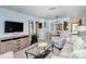 Open-concept living space with TV, comfortable seating, and dining area, all with coastal charm at 925 Beach Rd # 408, Sarasota, FL 34242