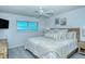 Cozy main bedroom featuring a comfortable bed, ceiling fan, and a window with a scenic ocean view at 925 Beach Rd # 408, Sarasota, FL 34242