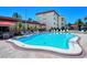 Stunning pool area featuring a tiled deck, comfortable lounge chairs, and meticulous landscaping at 925 Beach Rd # 408, Sarasota, FL 34242