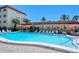Bright community pool with lounge chairs, tables and umbrellas ready for entertaining at 925 Beach Rd # 408, Sarasota, FL 34242