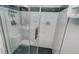 Walk in shower with glass door and white marble tiled walls with black tiled accents at 925 Beach Rd # 408, Sarasota, FL 34242