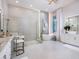 Modern bathroom featuring a glass enclosed shower, soaking tub and a double vanity sink with granite countertops at 1166 Blue Shell Loop, Sarasota, FL 34240
