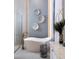 Bright bathroom showcases a luxurious white soaker tub complemented by decor, a stylish faucet, and modern finishes at 1166 Blue Shell Loop, Sarasota, FL 34240