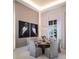 Elegant dining room with chic lighting, stylish artwork, and modern chairs perfect for entertaining at 1166 Blue Shell Loop, Sarasota, FL 34240
