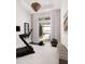 Bright exercise room with modern equipment and an open view of the pool and water, great for workouts at 1166 Blue Shell Loop, Sarasota, FL 34240