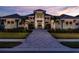 Stunning two-story home features beautiful landscaping and a brick driveway leading to the home's entrance at 1166 Blue Shell Loop, Sarasota, FL 34240