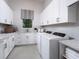 Well-equipped laundry room featuring modern appliances and white cabinets at 1166 Blue Shell Loop, Sarasota, FL 34240