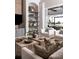 Cozy living room features custom shelving, decor, and comfortable seating, creating a welcoming atmosphere at 1166 Blue Shell Loop, Sarasota, FL 34240