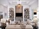 Inviting living room with custom shelving and neutral furniture creates a relaxing and stylish interior at 1166 Blue Shell Loop, Sarasota, FL 34240