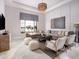 Bright living room boasts a large window view, with a comfortable couch, chairs, and round coffee table at 1166 Blue Shell Loop, Sarasota, FL 34240