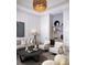 Living room features stylish seating, a decorative wall unit, and a charming round coffee table with accent lighting at 1166 Blue Shell Loop, Sarasota, FL 34240