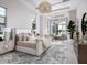 Airy primary bedroom offers a serene space with waterfront views, soft textures, and elegant details at 1166 Blue Shell Loop, Sarasota, FL 34240