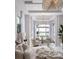 This bright and airy primary bedroom features serene waterfront views, soft colors, and stylish decor at 1166 Blue Shell Loop, Sarasota, FL 34240