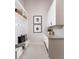 Bright mudroom with white cabinetry, bench seating, and decor at 1166 Blue Shell Loop, Sarasota, FL 34240