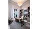 Bright office features a large window, a custom desk, and gray built-in bookshelves with decorative items at 1166 Blue Shell Loop, Sarasota, FL 34240