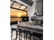 Outdoor kitchen with lake view at sunset at 1166 Blue Shell Loop, Sarasota, FL 34240