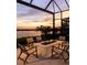 Outdoor fire pit seating area overlooking the lake at sunset at 1166 Blue Shell Loop, Sarasota, FL 34240