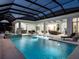 A luxury pool area with integrated spa and outdoor seating areas at 1166 Blue Shell Loop, Sarasota, FL 34240