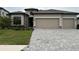 Charming one-story home with a paver driveway, neutral color palette and well-manicured landscaping at 15437 White Linen Dr, Bradenton, FL 34211