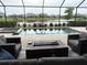 Screened-in backyard with pool, spa, outdoor seating, and a view of the lake at 15437 White Linen Dr, Bradenton, FL 34211
