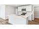Modern kitchen featuring stainless appliances, a spacious island with stone countertops at 17386 Whiskey Creek Trl, Parrish, FL 34219