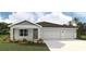 Charming single-story home featuring a two-car garage and a well-maintained lawn and landscape at 17460 Whiskey Creek Trl, Parrish, FL 34219