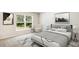 Serene bedroom with a neutral color palette, large window view, and comfortable furnishings at 1774 Cobb Trl, Parrish, FL 34219