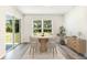 Bright dining area featuring a wood table set, modern decor, and large sliding glass doors at 1774 Cobb Trl, Parrish, FL 34219