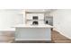 Bright kitchen featuring a large island, stainless steel appliances, and sleek, white cabinets at 1774 Cobb Trl, Parrish, FL 34219