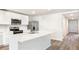 Well-lit kitchen with an island, stainless steel appliances, and ample counter space at 1774 Cobb Trl, Parrish, FL 34219