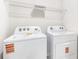 Efficient laundry area featuring white washer and dryer units with storage shelf above at 1774 Cobb Trl, Parrish, FL 34219