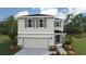 Charming two-story home with a neutral color scheme, gray shutters and stone accents on a landscaped yard at 1910 Cobb Trl, Parrish, FL 34219