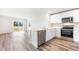 Well-lit kitchen featuring stainless steel appliances, white cabinets, and a marble island at 1926 Cobb Trl, Parrish, FL 34219