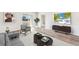Comfortable living room featuring a contemporary design, hardwood floors, and abundant natural light at 1926 Cobb Trl, Parrish, FL 34219