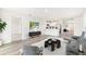 Open-concept living room with stylish decor, hardwood floors, and seamless access to the modern kitchen at 1926 Cobb Trl, Parrish, FL 34219