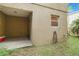 Back of the property with an enclosed patio and a small window at 2303 28Th E Ave, Palmetto, FL 34221