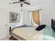 Cozy bedroom featuring a ceiling fan, a window with natural light, and comfortable furnishings at 2303 28Th E Ave, Palmetto, FL 34221